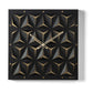 Orologio da parete Wallpape finitura nero/miele dal carattere moderno e originale, con struttura scatolare in ferro e superficie decorata con tagli ispirati all'origami. Vista frontale.